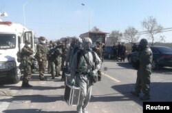 Paramilitary police officers in protective suits make their way to the site following explosion at the pesticide plant owned by Tianjiayi Chemical, in Xiangshui county, Yancheng, Jiangsu province, China, March 22, 2019.