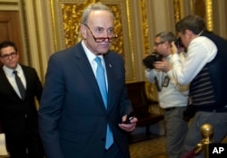Sen. Charles Schumer, D-N.Y., walks to the Senate chamber after a closed meeting with fellow Democrats on Capitol Hill, Jan. 19, 2018, in Washington.