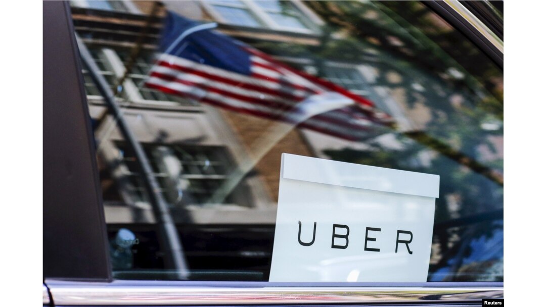 An Uber sign is seen in a car in New York, June 30, 2015.