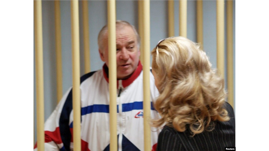 FILE - Sergei Skripal, a former colonel of Russia's GRU military intelligence service, looks on inside the defendants' cage as he attends a hearing at the Moscow military district court, Russia, Aug. 9, 2006.