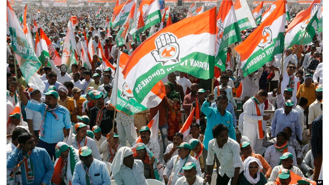 FILE - Supporters of India's main opposition Congress party attend a public meeting at Adalaj in Gandhinagar, India, March 12, 2019.