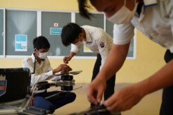 Students of the National Polytechnic Institute of Cambodia prepare their manned drone for flight, in Phnom Penh, Cambodia, September 17, 2021. (REUTERS/Cindy Liu)