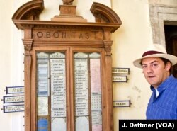 Benjamin Harnwell standing by what he dubs a medieval equivalent of modern-day mobile messaging apps - a board Cistercian monks used to communicate tasks for the day to avoid having to talk and disturbing “the atmosphere of silence” the Cistercians embrace.