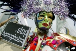 FILE - Gay rights activists demonstrate on the International Day Against Homophobia in Jakarta, Indonesia, May 17, 2008.
