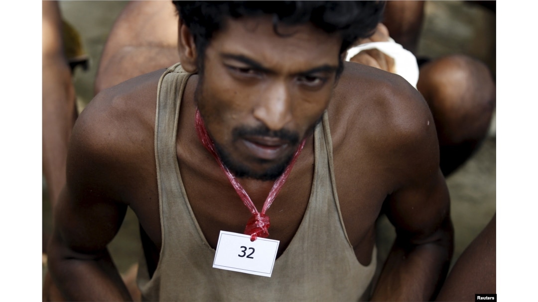 An identity number tag is seen on the neck of a migrant, who was found at sea on a boat, near Kanyin Chaung jetty after landing outside Maungdaw township, northern Rakhine state, Myanmar, June 3, 2015.