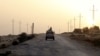 FILE - An Egyptian military vehicle is seen on a highway in northern Sinai, Egypt, May 25, 2015.
