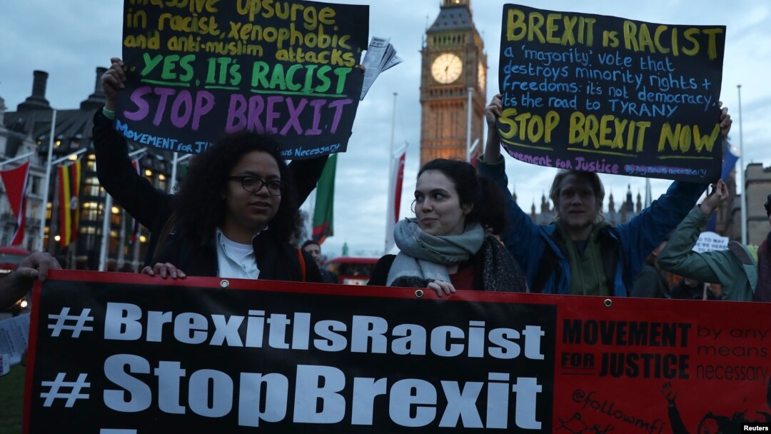 Demonstrators hold placards during a protest in favor of amendments to the Brexit Bill outside the Houses of Parliament, in London, Britain, March 13, 2017.