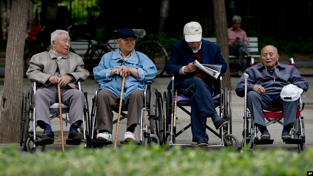 A group of elderly men take a rest on their wheelchairs at a park in Beijing, (File photo).