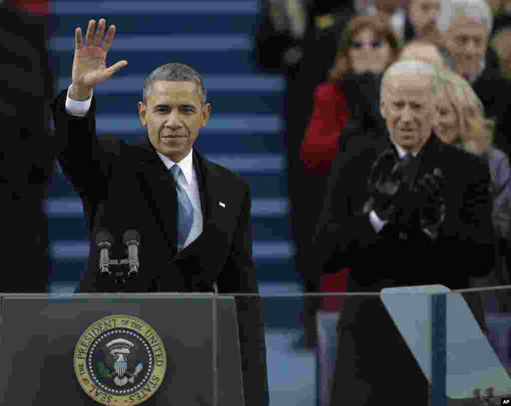 President Barack Obama waves after his speech while Vice President Joe Biden applauds at the ceremonial swearing-in at the U.S. Capitol, Jan. 21, 2013.