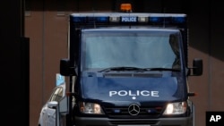 An armoured police van believed to carry Salih Khater drives out of the car park at Westminster Magistrates court in London, Monday, Aug. 20, 2018. A driver whose car collided with several people before crashing outside Britain's Parliament has been…