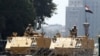 Egyptian soldiers stand guard as they close one of the entrances to Tahrir Square in Cairo, Aug. 23, 2013.