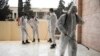 Members of a humanitarian aid agency disinfect Ibn Sina hospital as prevention against coronavirus in the city of Idlib, Syria, Thursday, March 19, 2020. (AP Photo/Ghaith Alsayed)