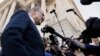 As a bitterly divided Congress moves toward a government shutdown, Senate Minority Leader Chuck Schumer, D-N.Y., center, speaks to the media outside the Capitol after meeting with President Donald Trump, Jan. 19, 2018, in Washington.