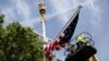 Workers hang a U.S. flag on The Mall towards Buckingham Palace in central London ahead of U.S. President Donald Trump state visit to Britain, June 2, 2019.