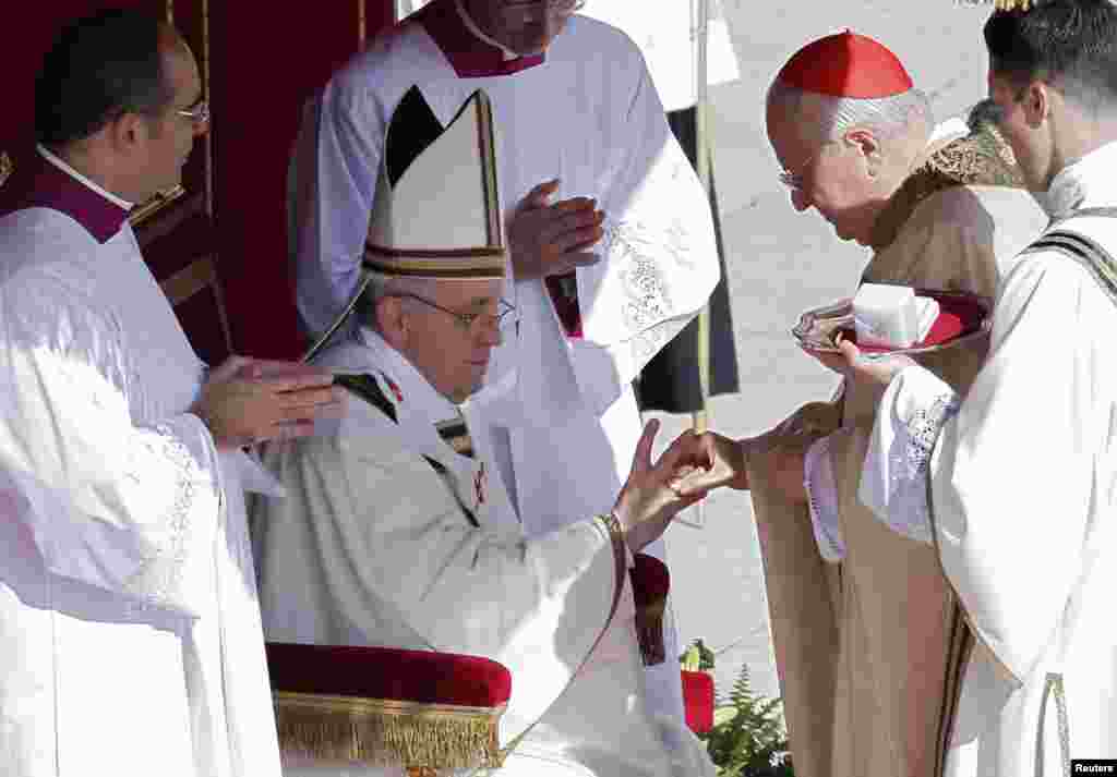 The Fisherman's Ring is placed on the finger of Pope Francis by Cardinal Angelo Sodano, Dean of the College of Cardinals, during his inaugural mass at the Vatican, March 19, 2013.