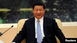 Chinese President Xi Jinping attends a meeting with French Foreign Minister Laurent Fabius at the Great Hall of the People in Beijing April 12, 2013. 