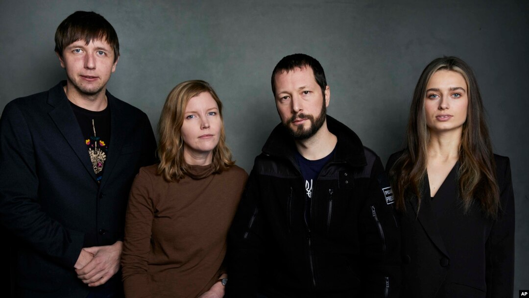 FILE - From left, photographer Evgeniy Maloletka, "Frontline" producer Michelle Mizner, director Mstyslav Chernov and field producer Vasilisa Stepanenko pose for a portrait to promote "20 Days in Mariupol" during the Sundance Film Festival on Jan. 22, 2023, in Park City, Utah.