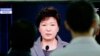 People watch a live television program showing South Korean President Park Geun-hye's speech to the nation regarding the sunken ferry Sewol at the Seoul Train Station in Seoul, South Korea, Monday, May 19, 2014.