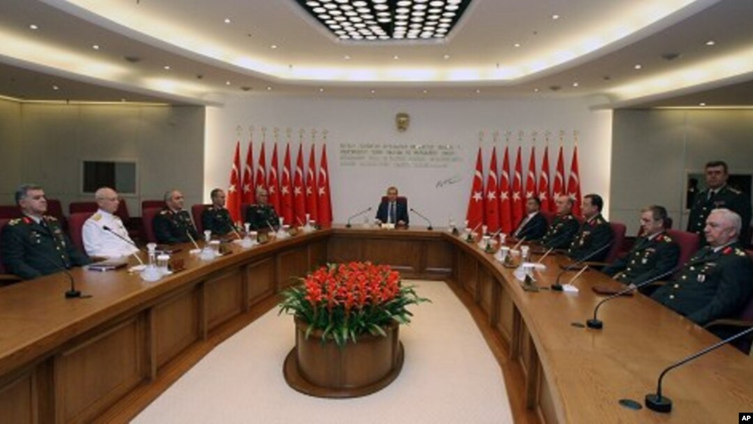 Gen. Necdet Ozel, Turkey's new Land Forces Commander and acting Chief of Staff, 5th from left, PM Erdogan, center, and Defense Minister Ismet Yilmaz, 5th from right, are seen during the military's annual meeting in Ankara, Turkey, August 1, 2011