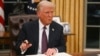 FILE - U.S. President Donald Trump signs an executive order on the U.S. withdrawal from World Health Organization in the Oval Office of the White House in Washington, on Jan. 20, 2025. 
