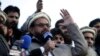 FILE - Hafiz Saeed, chief of Pakistani religious group Jamaat-ud-Dawa, addresses a rally for Kashmir Day in Lahore, Pakistan, Feb. 5, 2019.