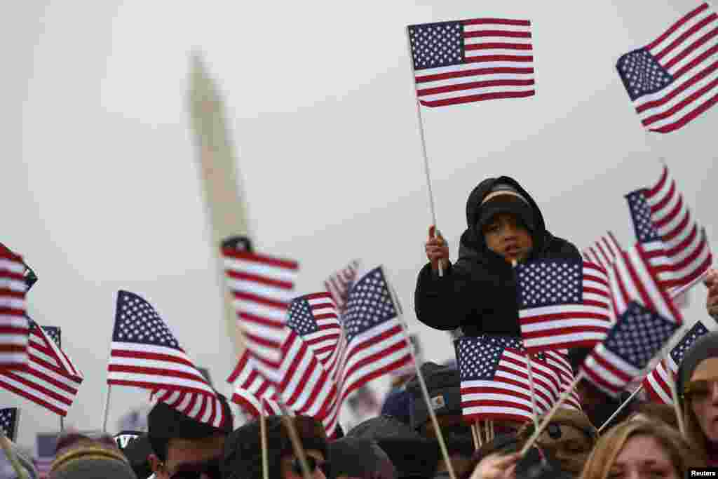 Spectators react on the National Mall during the 57th inauguration ceremonies for U.S. President Barack Obama and Vice President Joe Biden on the West front of the U.S. Capitol, in Washington, D.C., Jan. 21, 2013.