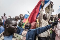 Russians and Malian flags are waved by protesters in Bamako, Mali, during a demonstration against French influence in the country on May 27, 2021.