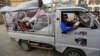 Yemenis deliver donations collected from citizens to help displaced people who fled the war-torn port city of Hodeida at a school used as a camp for displaced people in the capital Sanaa on June 22, 2018.
