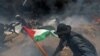 FILE - Palestinian demonstrators run for cover from Israeli fire and tear gas during a protest against U.S. embassy move to Jerusalem and ahead of the 70th anniversary of Nakba, at the Israel-Gaza border in the southern Gaza Strip, May 14, 2018. 