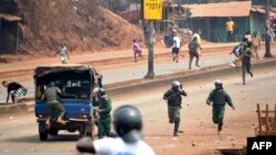 People clash with riot police during a demonstration against the results of the local elections in Conakry, Feb. 6, 2018.
