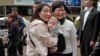 Hong Kong's chief executive elect Carrie Lam (center right) poses with local residents in Hong Kong, March 27, 2017.