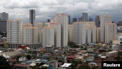 Rows of condominium buildings are seen behind a middle-class residential district in Mandaluyong, Metro Manila, July 4, 2012.