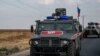FILE - Russian forces patrol near the city of Qamishli, north Syria, Oct. 24, 2019.