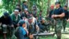 FILE - In this undated photo, Abu Sayyaf spokesperson Abu Sabaya, right foreground, is seen with his band of armed extremists. 