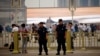 Policemen stand on the road at Tiananmen Square on a hazy day in Beijing on the 24th anniversary of a military crackdown on a pro-democracy movement, June 4, 2013.