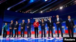 FILE - Democratic U.S. presidential candidates before the start at the 2020 Democratic U.S. presidential debate in Houston, Sept. 12, 2019.