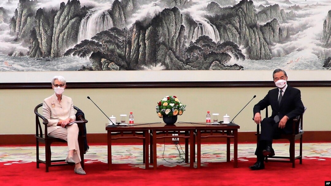 In this photo provided by the U.S. Department of State, U.S. Deputy Secretary of State Wendy Sherman, left, and Chinese Foreign Minister Wang Yi sit together in Tianjin, China, Monday, July 26, 2021. China came out swinging at high-level face-to…