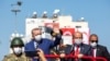 Turkish President Recep Tayyip Erdogan, left, and Turkish Cypriot leader Ersin Tatar, right, take part in a parade in the northern part of Cyprus' divided capital Nicosia, in the self-declared Turkish Republic of Northern Cyprus, July 20, 2021. 
