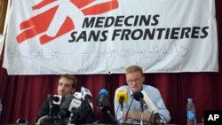 The general director of medical charity, Medecins Sans Frontieres (MSF), Christopher Stokes, right, talks as MSF's Country Representative for Afghanistan, Guilhem Molinie, left, listens, during a press conference at their office, in Kabul, Afghanistan, Oct. 8, 2015.