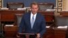 FILE - U.S. Senator Jeff Flake, R-Ariz., speaks on the Senate floor in Washington, Oct. 24, 2017. He says he's had a "long-term interest" in Zimbabwe and thinks President Robert Mugabe will go down in history "as a long-serving thug."