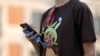 A young man's T-shirt gives him away — he's a Pokemon fan. 