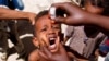 FILE - A health worker drops anti-polio vaccine into the mouth of a Somali child in Mogadishu September 10, 2006.