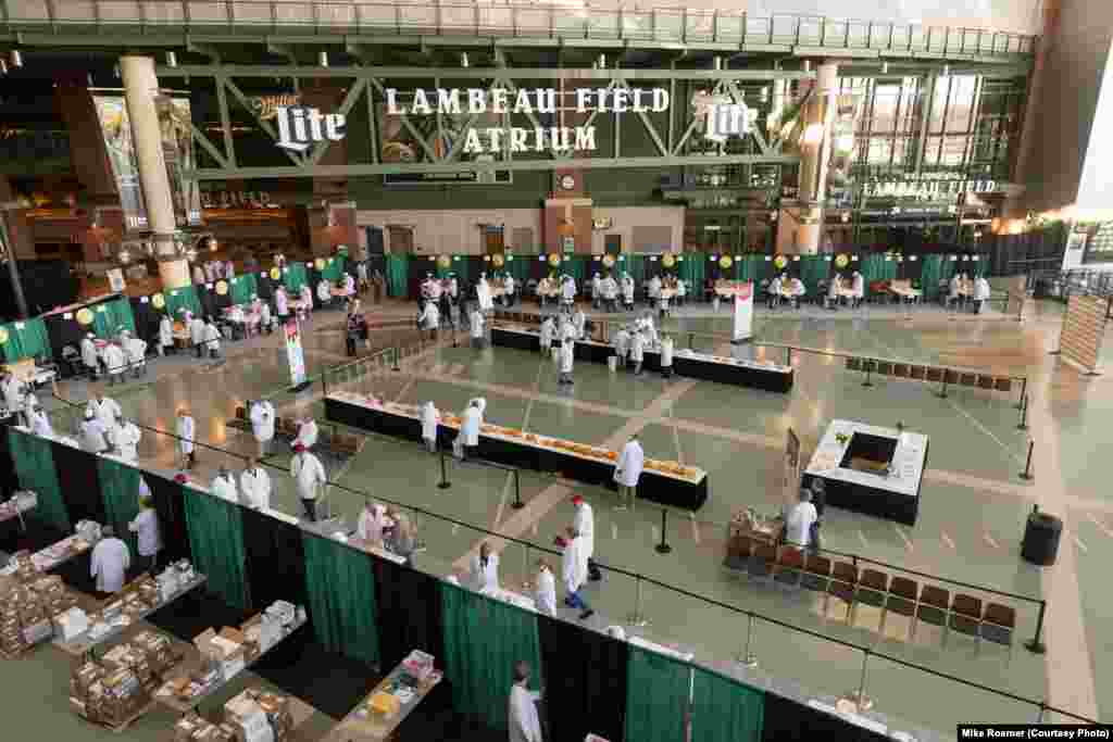 Judging for the U.S. Championship Cheese Contest is held in the atrium of Lambeau Field, Green Bay, Wis., March 5, 2019. The judging is open to the public and visitors watch judges and sample cheeses.
