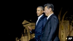 President Barack Obama and Chinese President Xi Jinping, right, walk on the North Lawn of the White House in Washington, Thursday, Sept. 24, 2015.