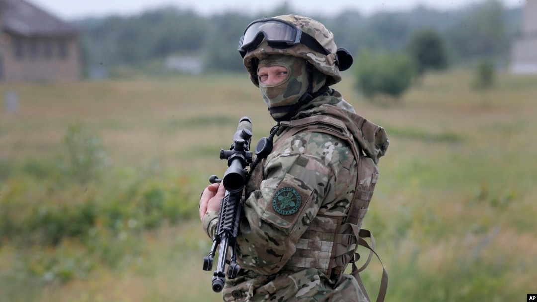 FILE - A Ukrainian soldier stands during training in a landfill at Chuguev, Ukraine, June 4, 2014.