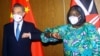 Chinese Foreign Minister Wang Yi and his Kenyan counterpart, Raychelle Omamo, bump elbows during a news conference in Mombasa, Kenya, Jan. 6, 2022. 