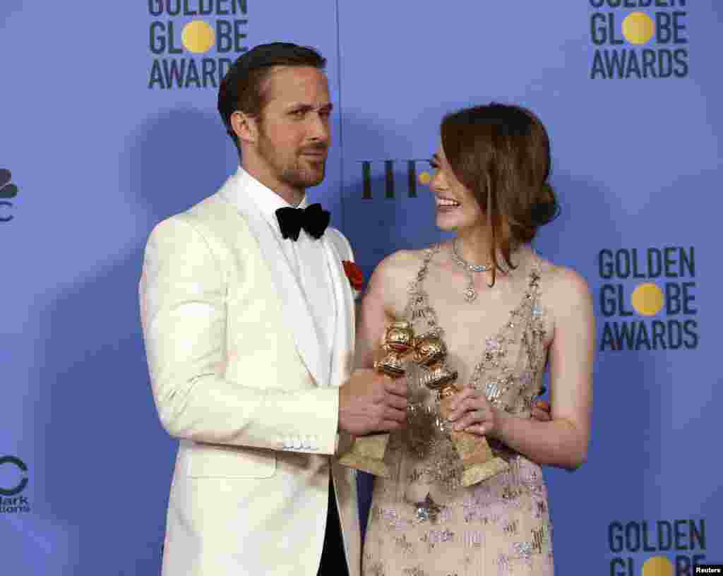 Ryan Gosling and Emma Stone pose with their awards for Best Performance by an Actor in a Motion Picture - Musical or Comedy and Best Performance by an Actress in a Motion Picture - Musical or Comedy for their roles in &quot;La La Land&quot; during the 74th Annual Golden Globe Awards in Beverly Hills, California, Jan. 8, 2017.
