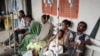 FILE - People who were injured in a deadly airstrike on a market in Togoga wait on a bench for medical treatments at Mekelle General Hospital in Mekelle, June 24, 2021.