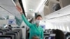 A flight attendant gives instructions to passengers on a plane in Ho Chi Minh City, Vietnam, March 16, 2020. 