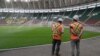 FILE - Workers from the Magil company standing near the pitch at the Olembe stadium in Yaounde, Cameroon, Aug. 8, 2021.